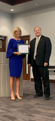Board member Cindy Price, left, is presented her Board Leadership Certificate by Board President Jeff Joines. 